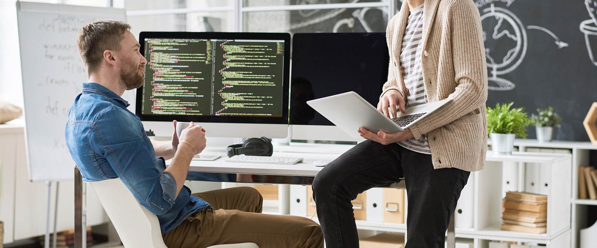 Developers meeting at their desk