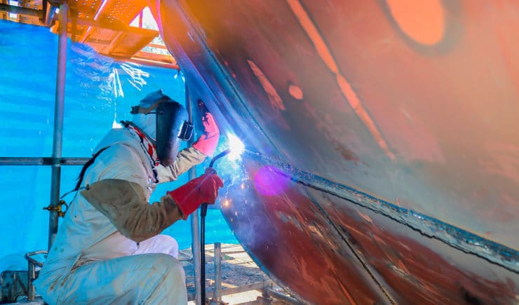 underwater welder repairing boat hull