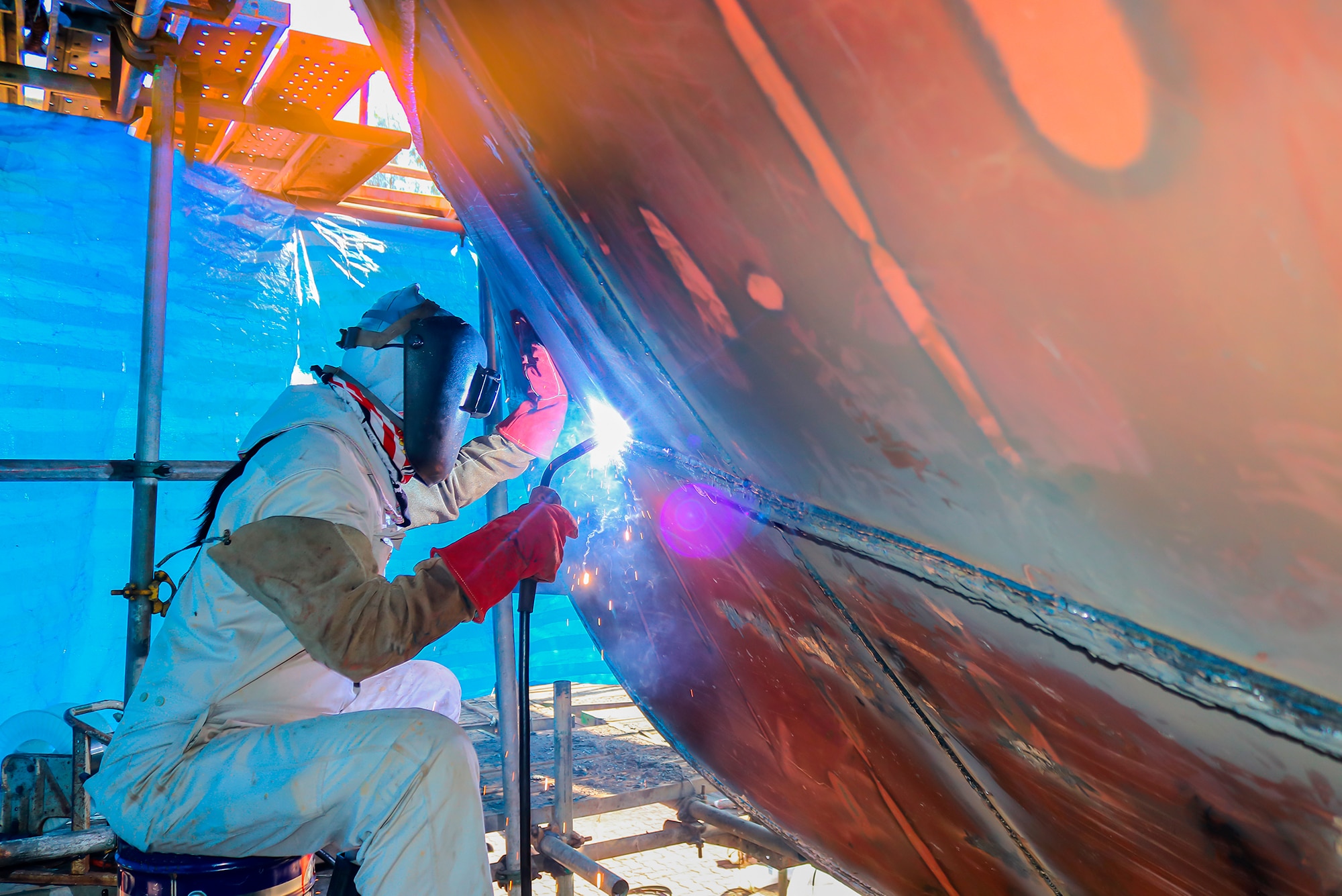 underwater welder repairing boat hull