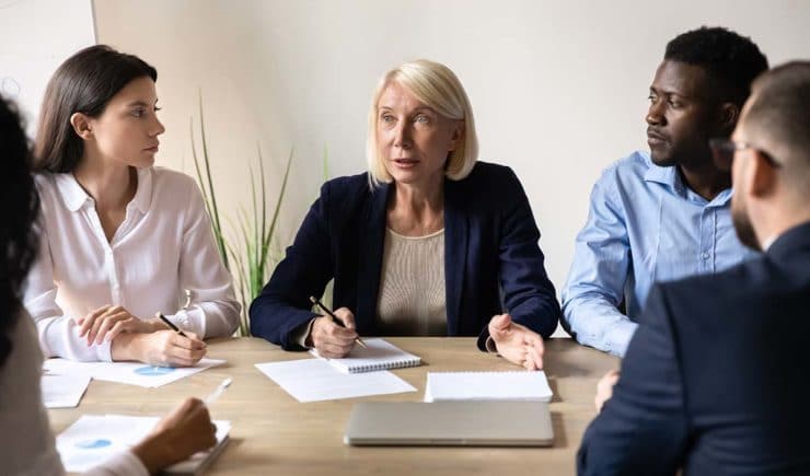 Group of business people at a table discussing a new business venture.