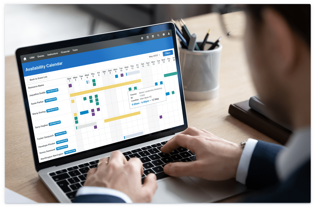 Businessman using the calendar feature in Administrate on a laptop.