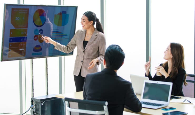 Business woman presenting to coworkers.