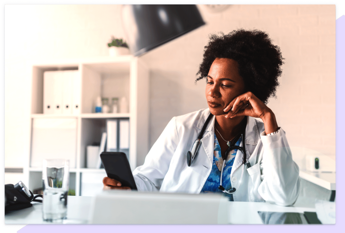 Doctor getting phone notification while at work.