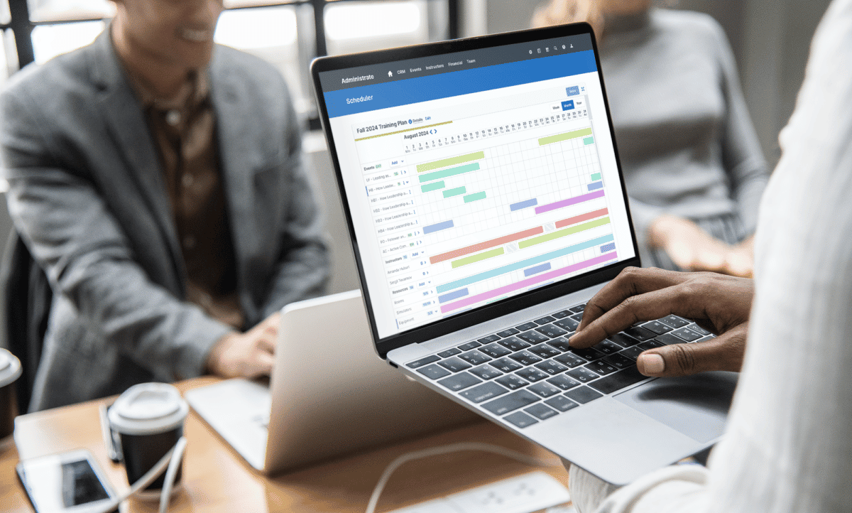 Business person navigating the Administrate platform feature Scheduler.