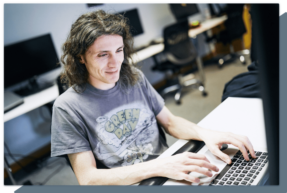 Software engineer working at his laptop in an office.