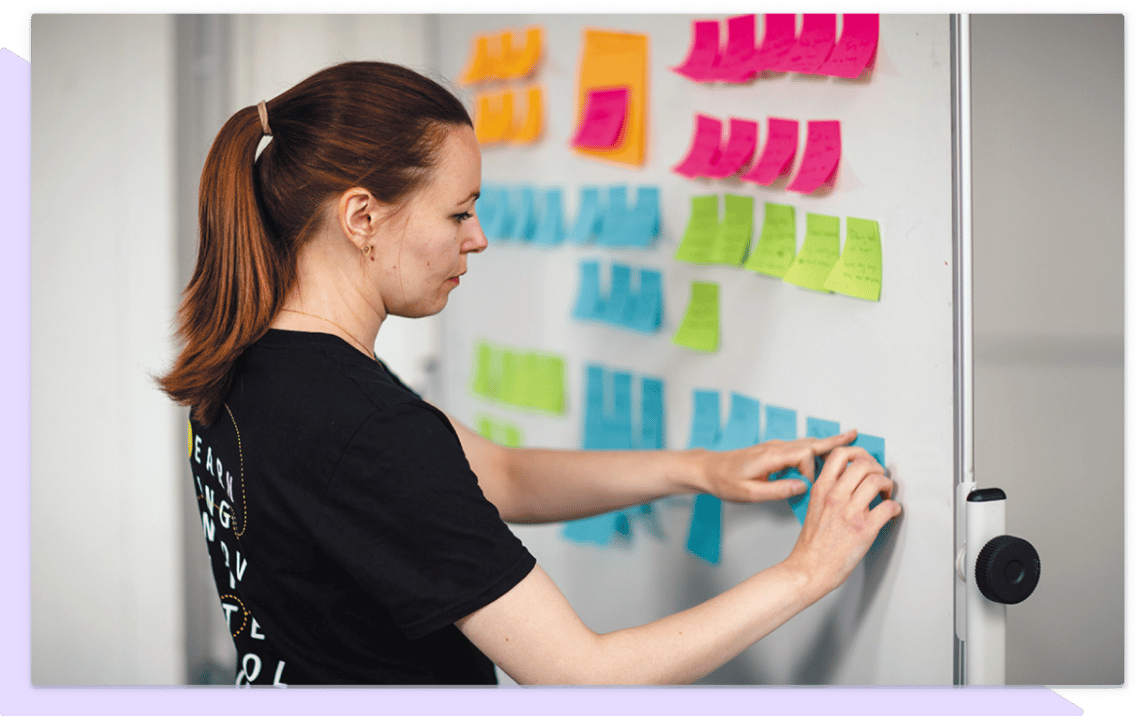 Woman using sticky notes in a workshop.