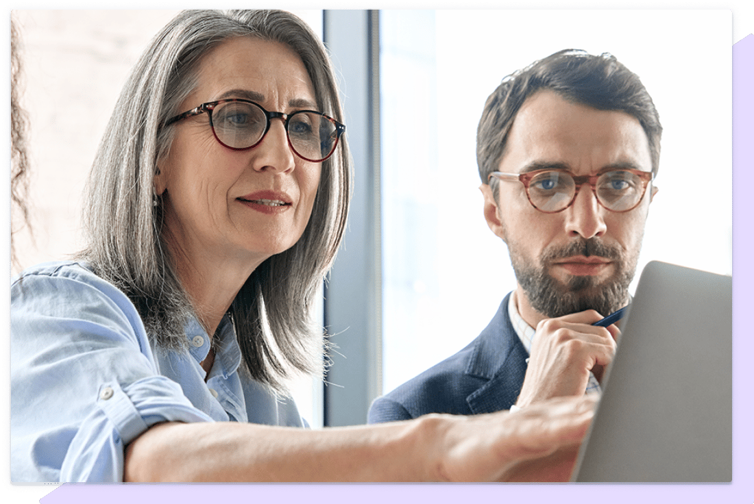 Support team working with a customer on a laptop.