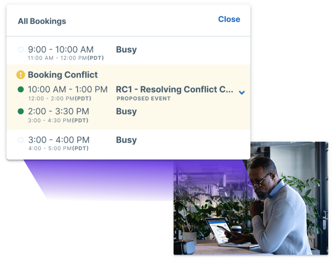 Man receiving notification of scheduling conflict while using Scheduler.