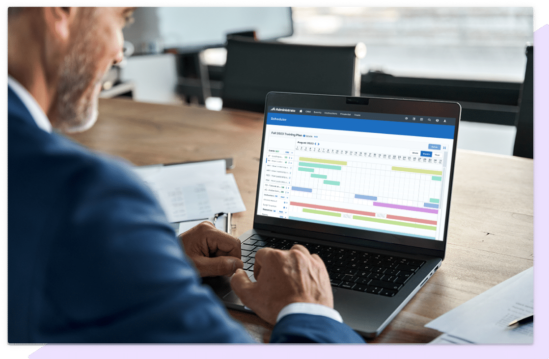A training professional using Administrate’s Scheduler on a laptop.