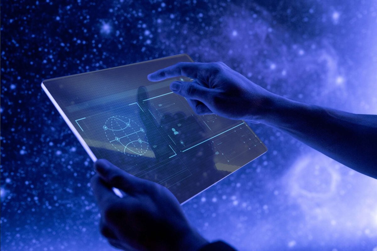 Person holding handheld tablet display with charts over a starry background.