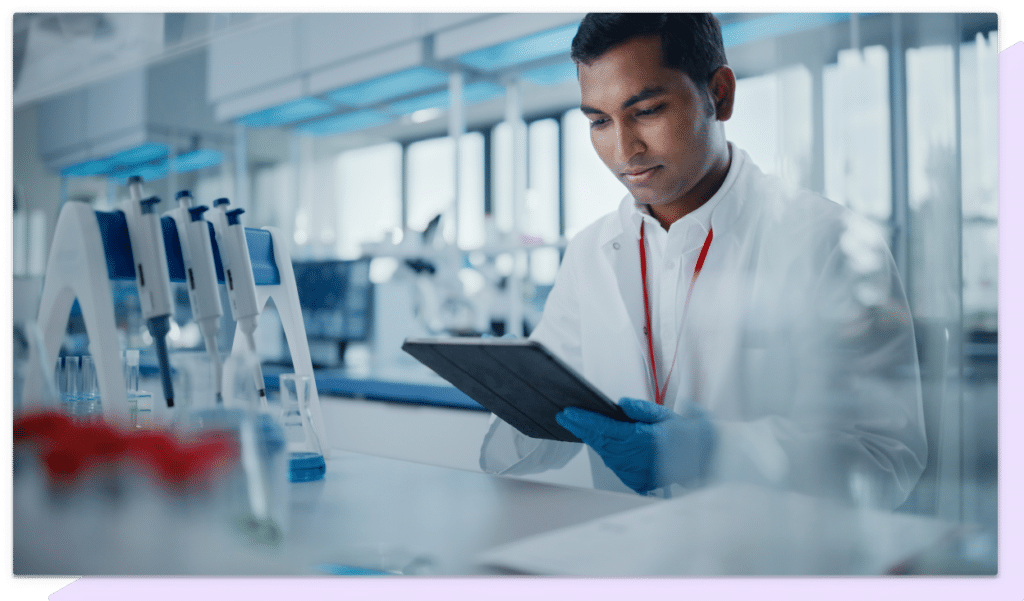 A doctor reads a tablet computer in a hospital laboratory.