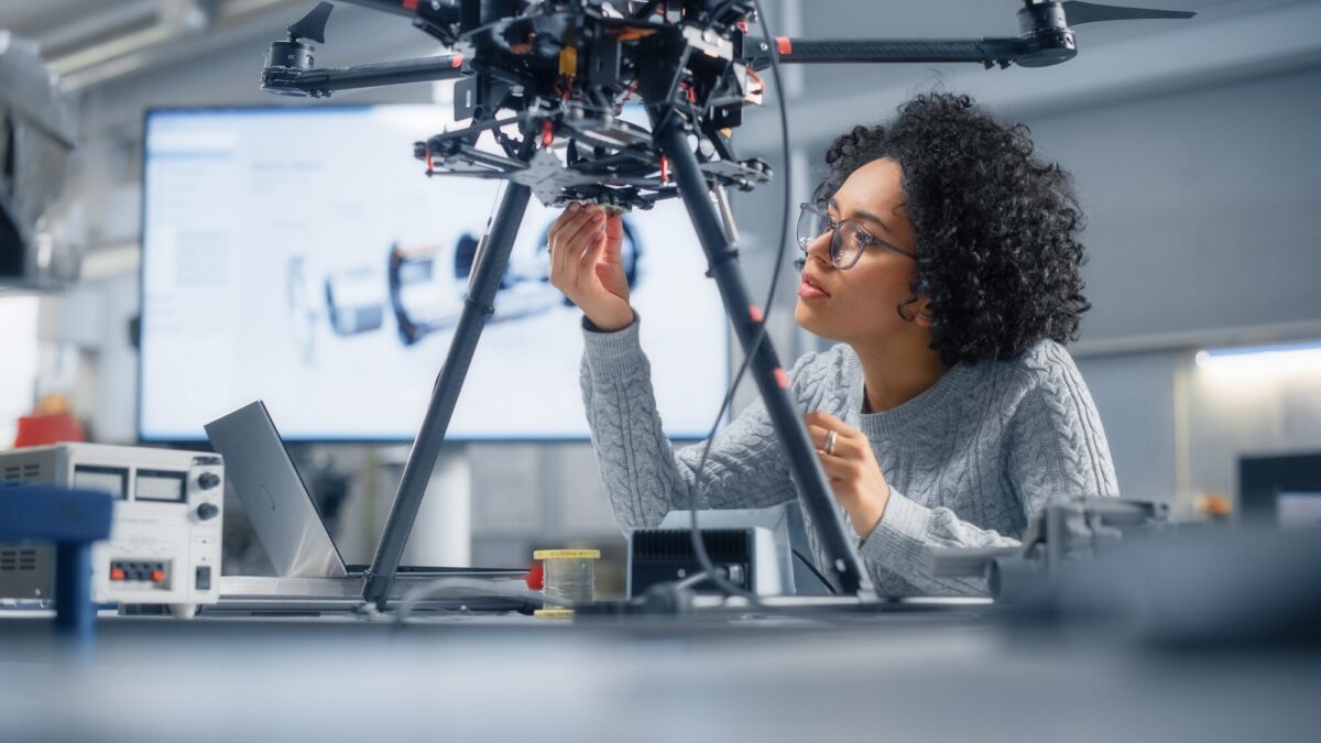 Woman engineer in a hands-on course working on a electrical unit.