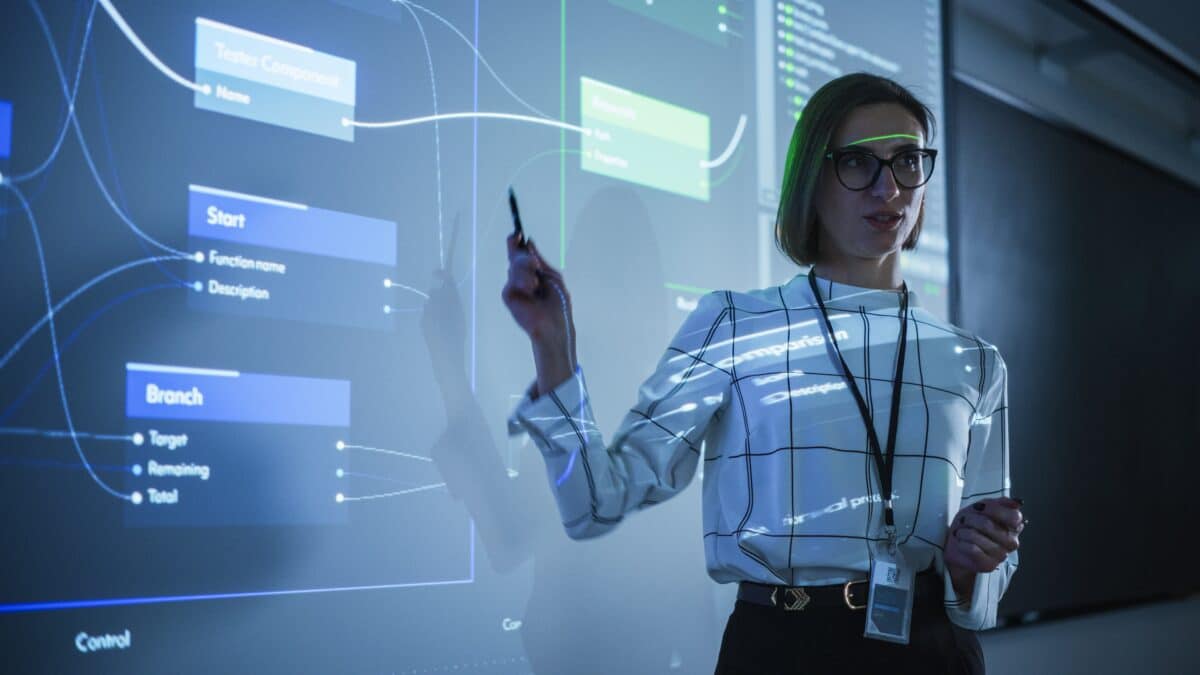 An image of an instructor pointing to a diagram while leading a class.