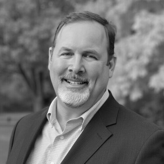Headshot of Brett Buzby.