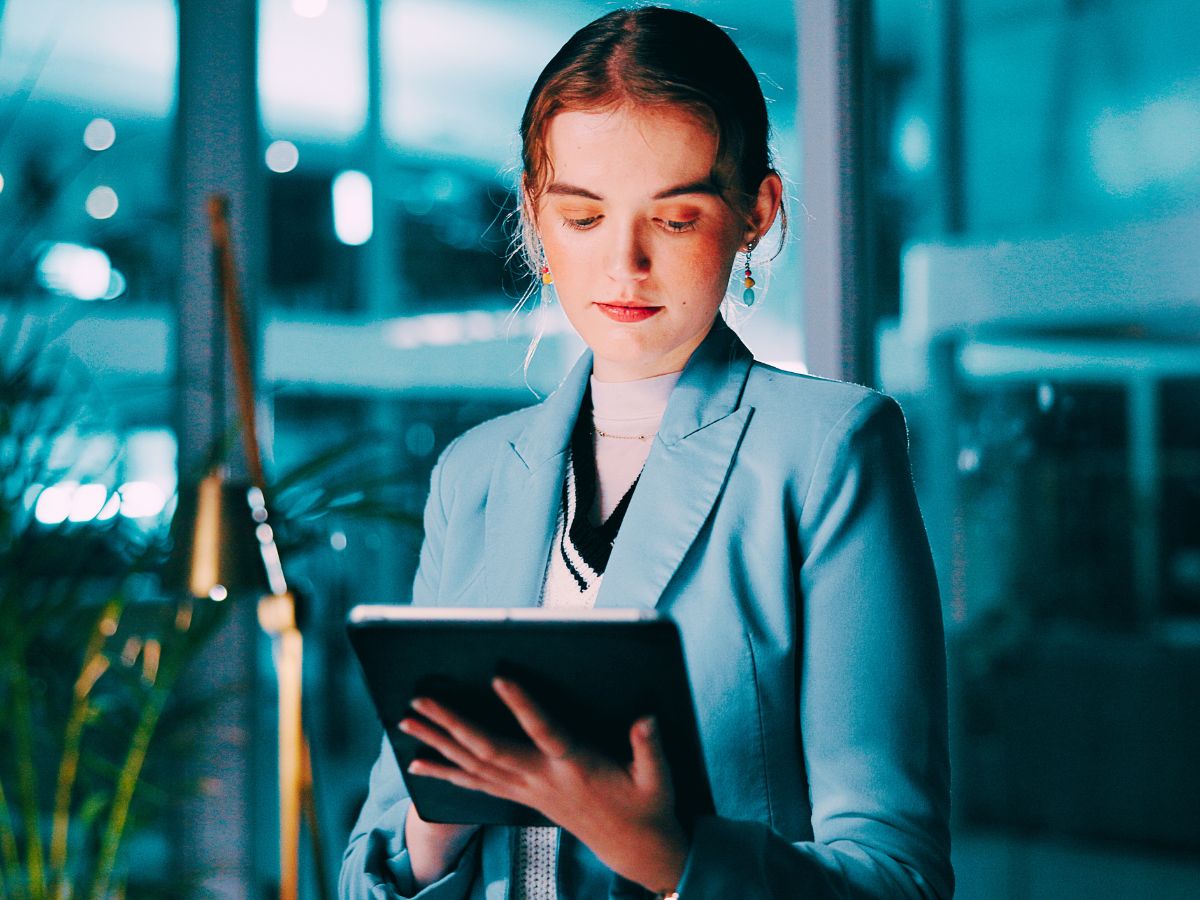 Audit professional reviews a tablet to ensure compliance