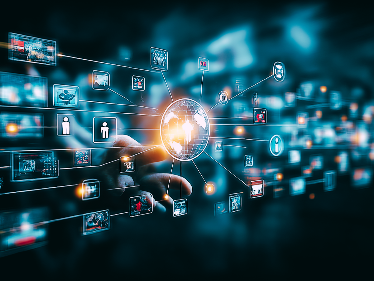 digital technology concept with a hand touching a digital network and icons representing video, social media, and global connection against a dark background.