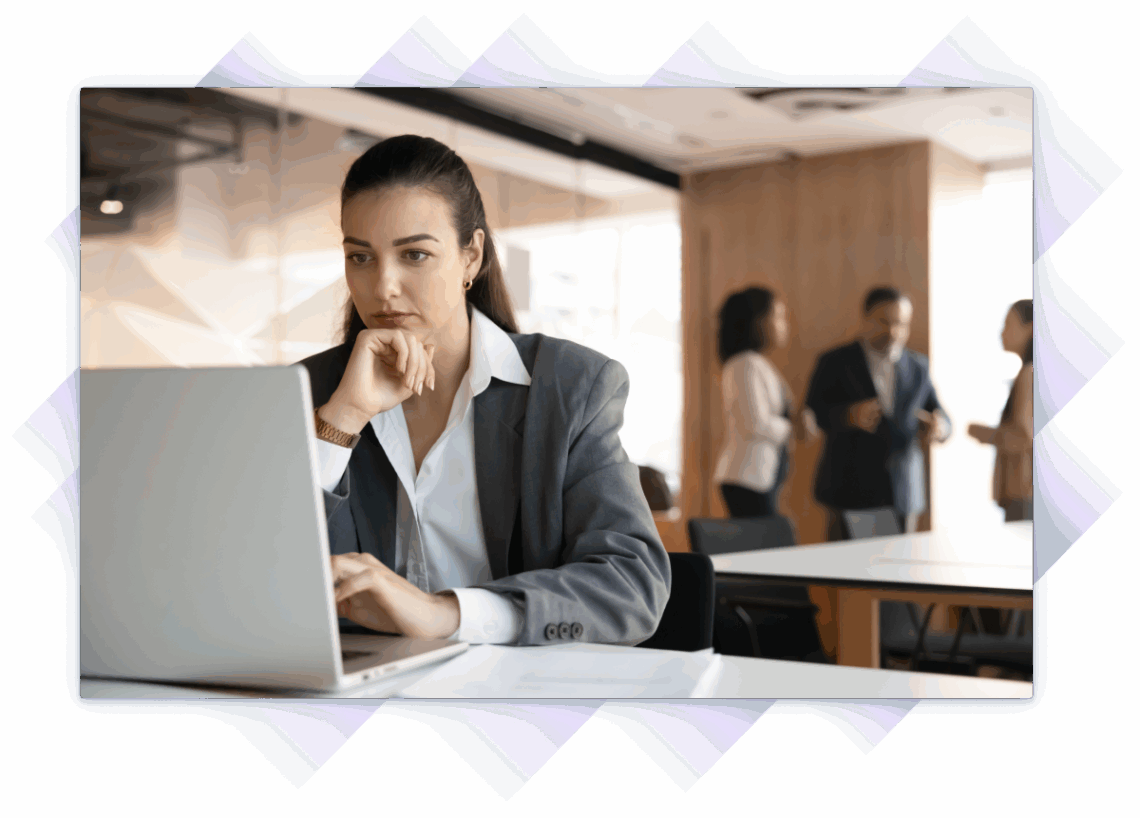 Businesswoman looks at laptop screen with serious expression in her office.