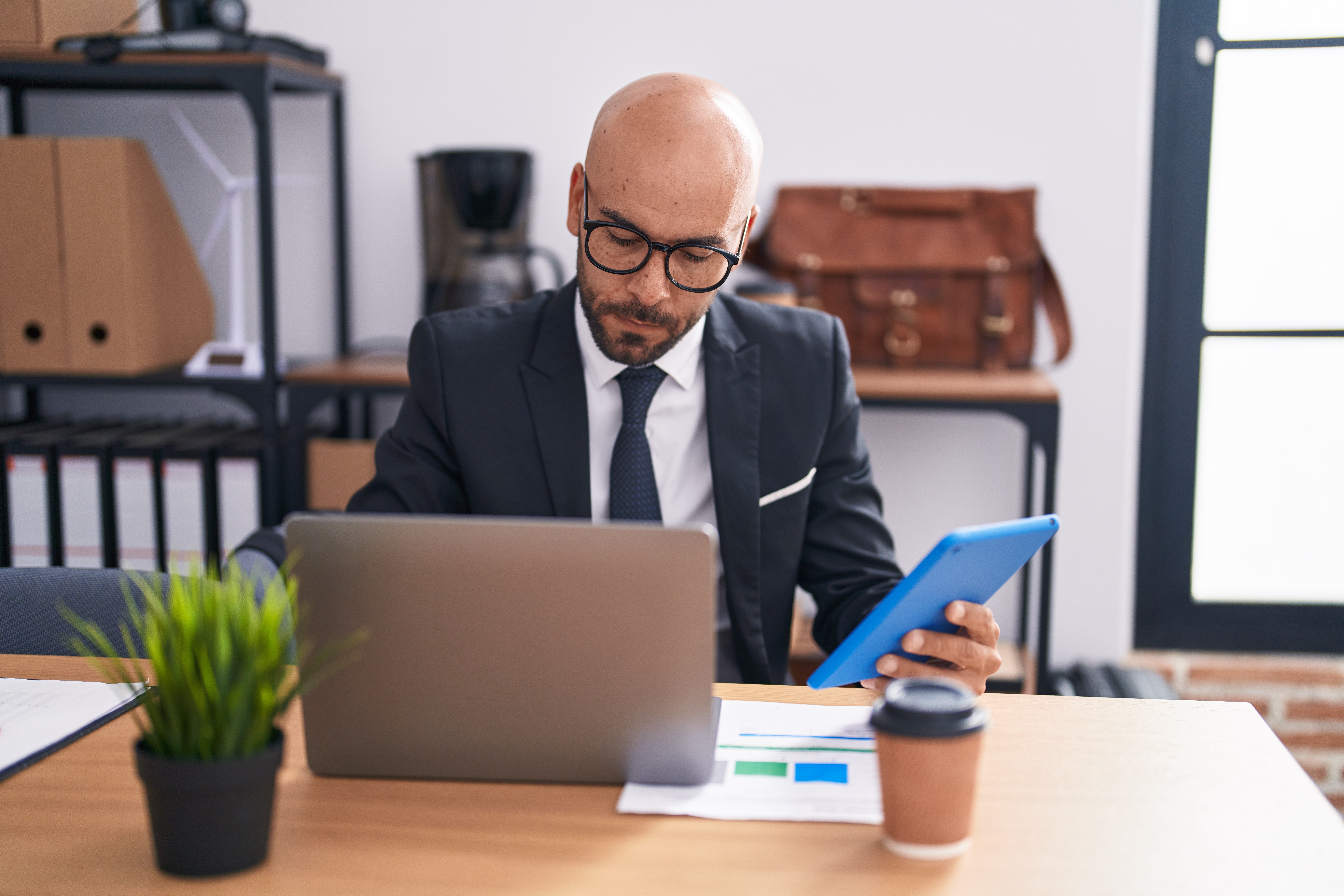 Businessman reviewing documents for compiance audit.