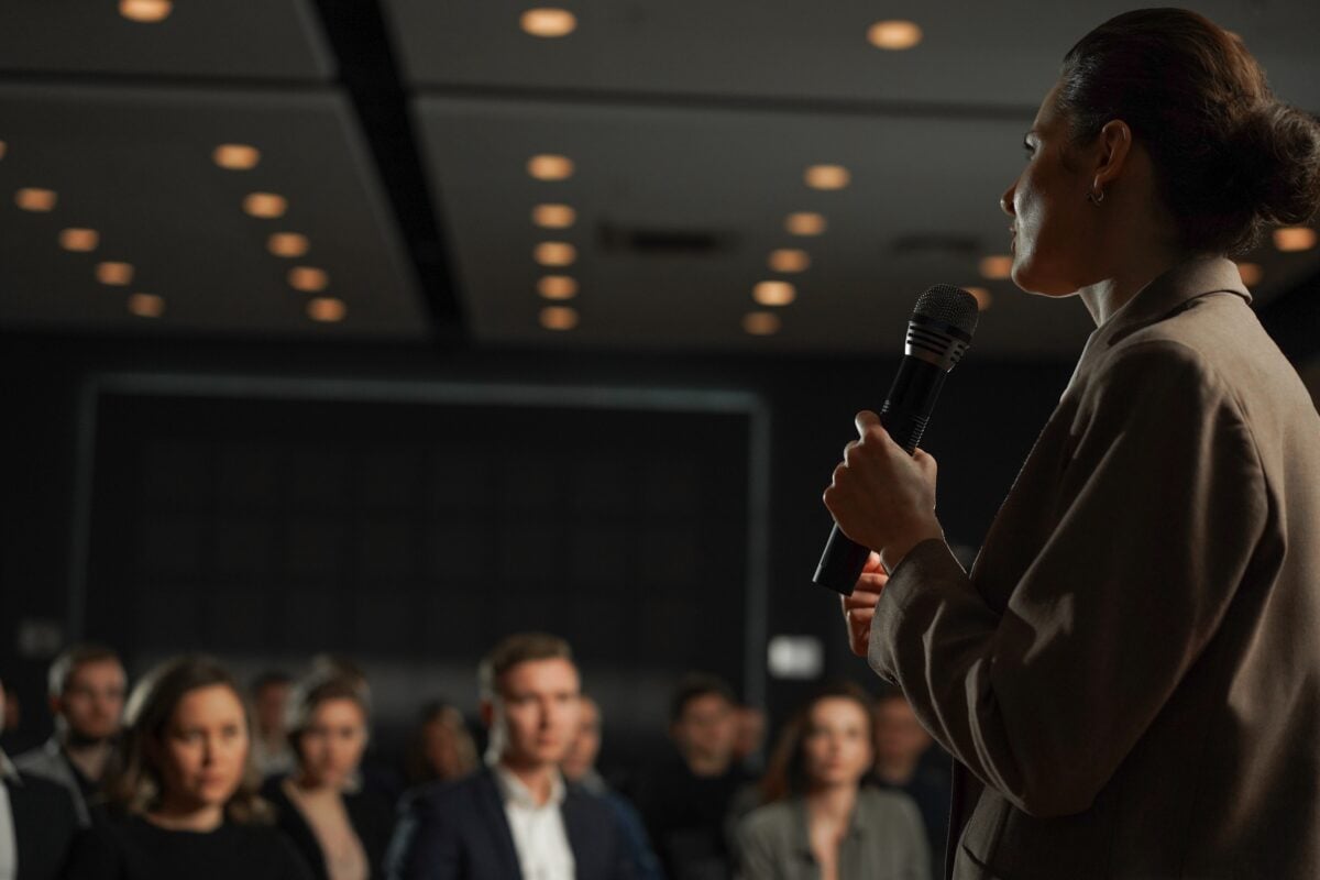 Woman speaking at training for professionals.