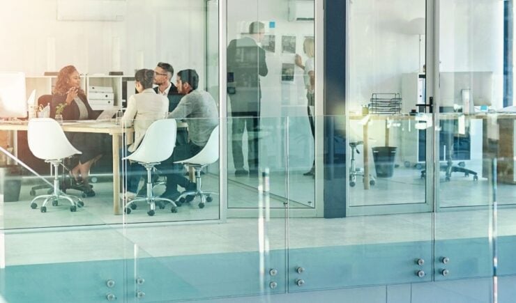 Group of training professionals in an office setting at a table.