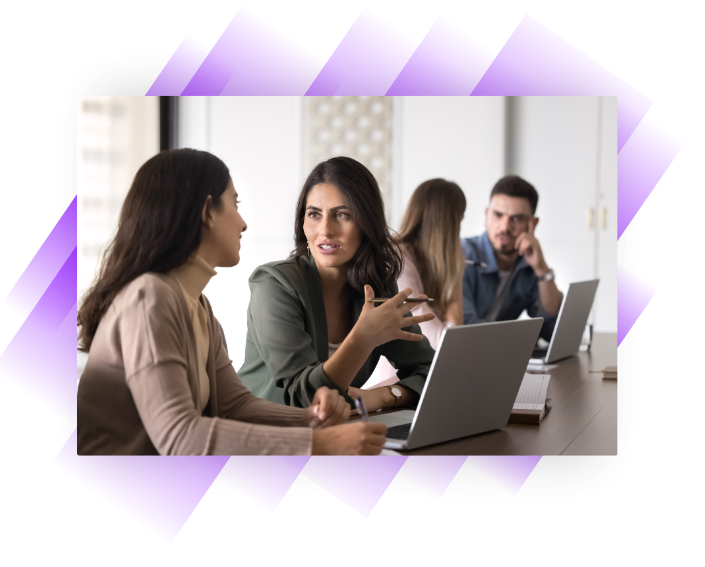 Woman accountant explaining something to an apprentice in an office setting.